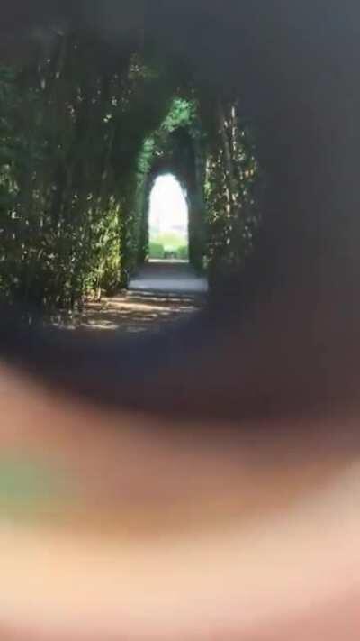 Peeking through Aventine keyhole in Rome, Italy.