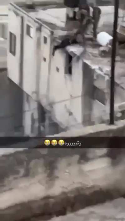 Israeli soldiers throw a Palestinian off a building in Jenin