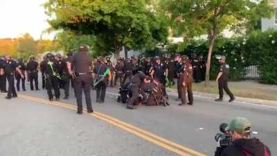 Cop has his knee on a woman's neck even though there are 3 cops on her already. A different cop notices it and pulls him away.