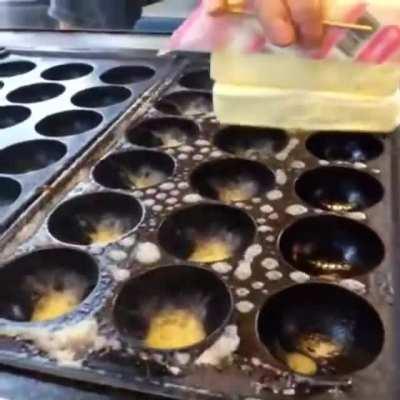 The sound buttering Takoyaki pans makes.