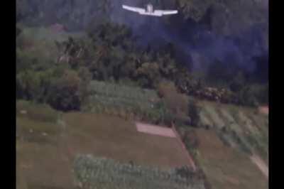 Wingman's perspective of a napalm tank dropped by a VA-196 A-1J Skyraider attacking Vietcong positions North of Saigon on July 2nd 1965