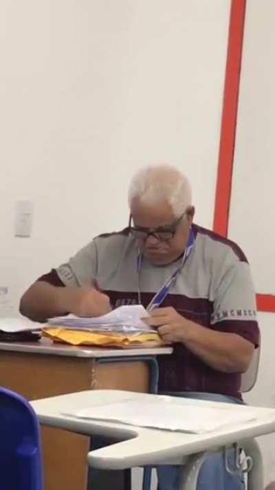 This teacher correcting exams while students are in class