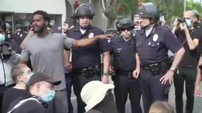 Activists cheer on Los Angeles police chief during George Floyd protest