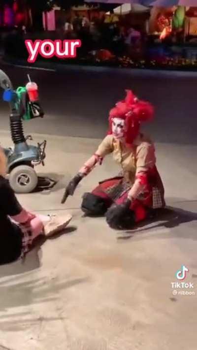 A clown giving a nice shoe tying lesson