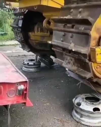 Using stacked car rims to put a tractor on a trailor