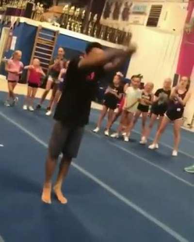 Teacher does a standing double backflip for the kids