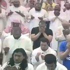 A guy with down syndrome tries to give a tissue to crying guy next to him praying.