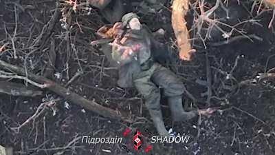 A Russian soldier, surrounded by his dead comrades, was struck with a direct hit from a dropped grenade by 