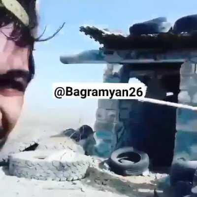 Armenian troops and volunteer fighters planting the Armenian Flag on a position they supposedly took from Azerbaijan.