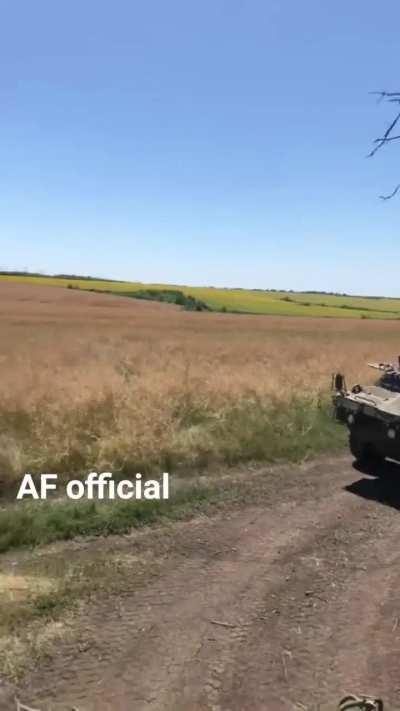 Ukrainian troops riding on US-supplied M1117 armored vehicles.