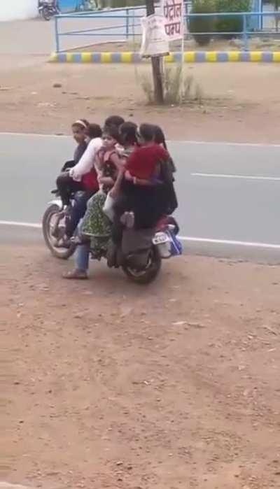 3 adults, 4 kids on a motorcycle