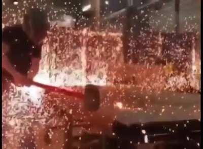 Flying sparks from hitting a hot metal ball