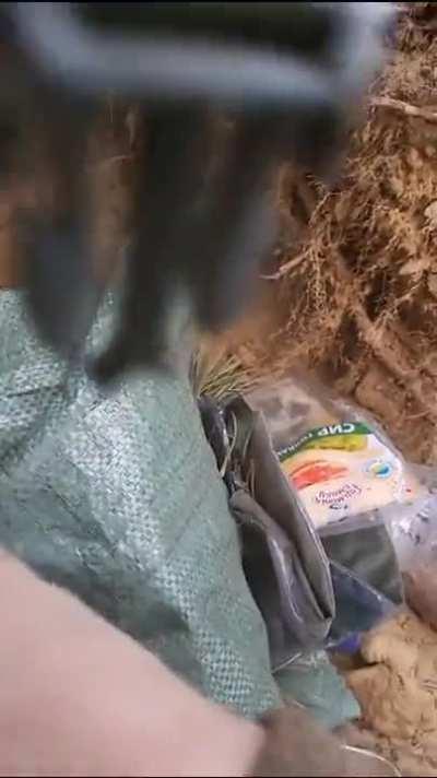 A shell-shocked Ukrainian soldier in a trench is getting taken care of, location and date unknown