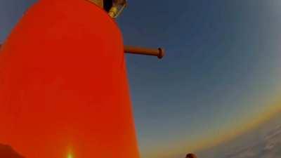 Maintenance worker climbs 2000 ft radio tower to change a light bulb.