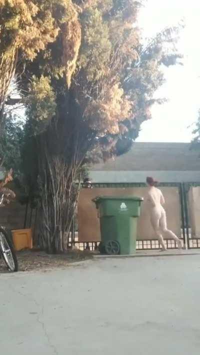 Naked girl gets the delivery at her front gate