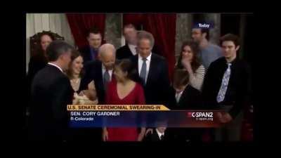 Biden being a creep pinches 8 year old girls nipple.