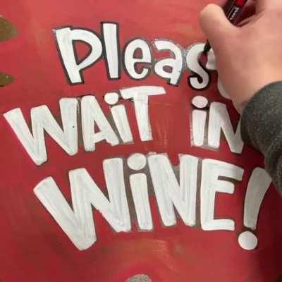 Please Wait in Wine. Social distancing floor sign art at work.