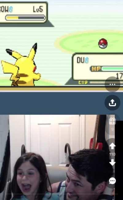 A young girl playing Pokemon with her dad for the first time and catching her first Pokemon