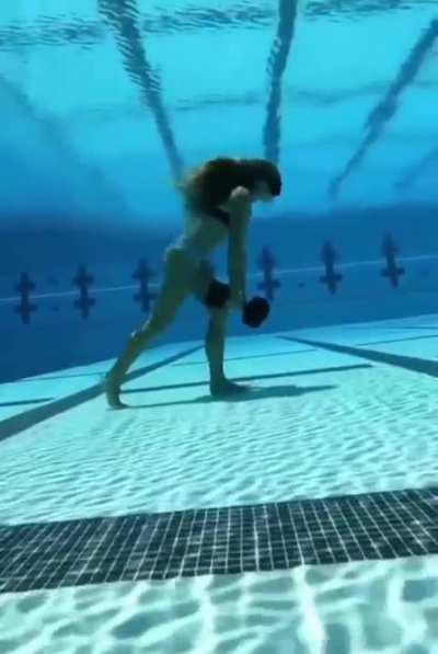 Freediving instructor shows her class how she trains in the pool.