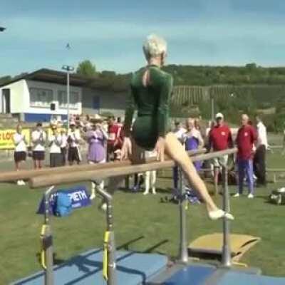 This elderly woman performing gymnastics on parallel bars is more impressive than any bar work Ive ever seen in my gym.