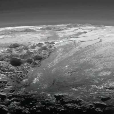 Pluto’s ice mountains: Frozen plains and layers of atmospheric haze backlit by a distant sun, as seen by the New Horizons spacecraft. Credit: NASA/JHUAPL/SwRi