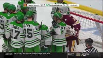 Minnesota-Duluth goalie Ryan Fanti consoles North Dakota goalie Adam Scheel after UMD wins the longest NCAA hockey tournament game ever