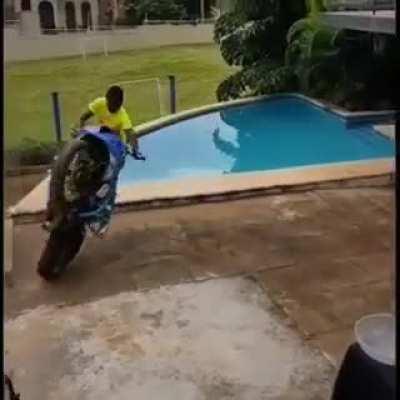 Yeah, do motorcycle tricks next to a pool of water...what could go wrong?