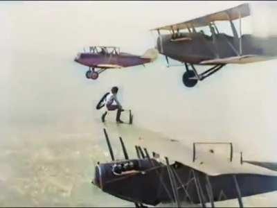 An extremely brave woman jumps from plane to plane to mid-air to change a landing gear. 1926.