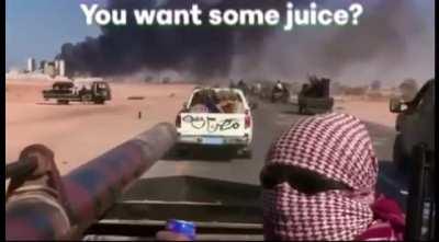 Rebel fighters in Libya asking filmmaker Olivier Sarbil if he’d like some juice during the battle of Sirte in 2011