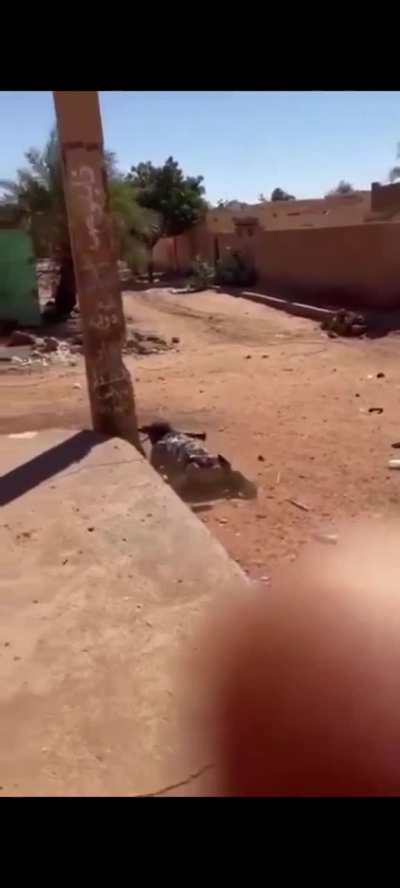 RSF fighter in Sudan fires a rocket launcher while crawling on the ground