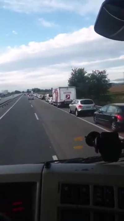 A bunch of idiots thought that the hard shoulder was the exit lane and started piling up behind a truck... who's telling them?