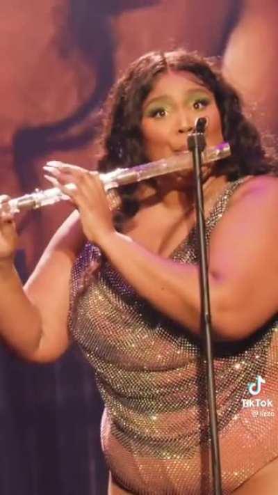 Lizzo playing the crystal flute