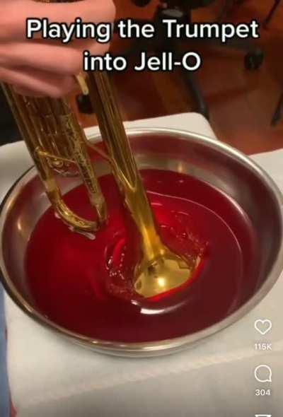 Trumpet being played through Jello