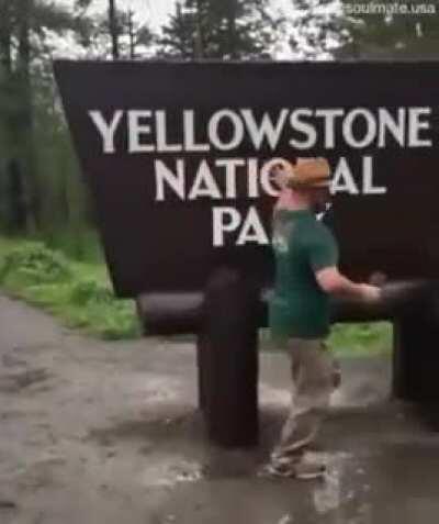 Adult is extremely happy to visit Yelloestone national park