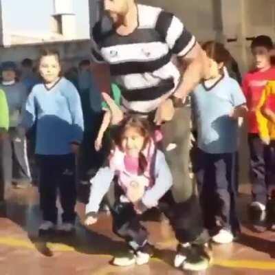 Gym teacher helps disable girl dance with her classmates!