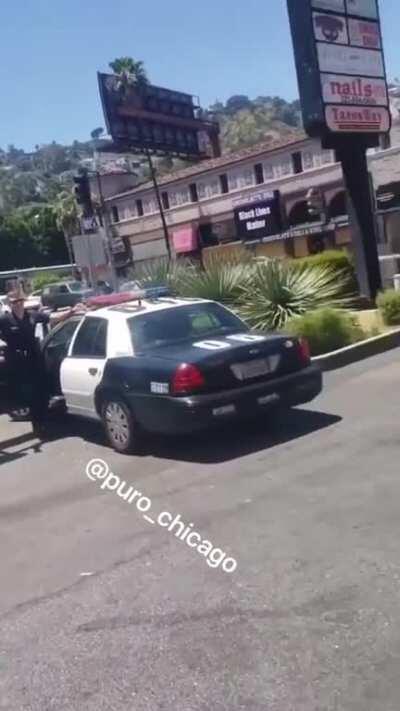 Man racially abuses Chinese man next to two cops while they just stand and watch