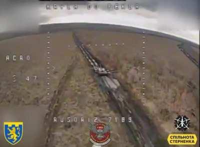 Russian tank gunner lowers his head in the turret hatch, to protect him from a FPV drone hit.