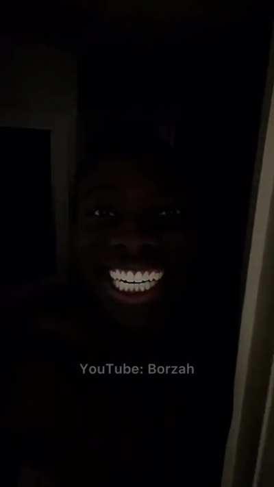black man smiling in the dark