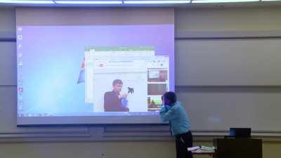 Math professor fixes projector screen.