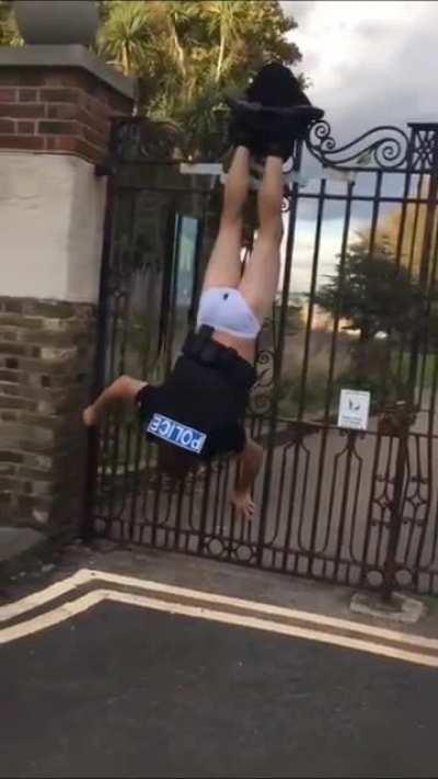 Cop gets stuck on a fence