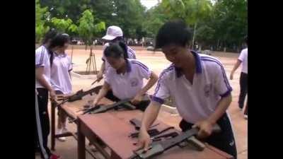 Vietnamese highschool students learning to assemble and disassemble AK-47s as their main curriculum.