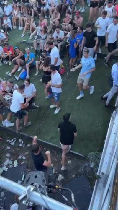 People slipping and falling down at Tomorrowland 2022 next to the urinals