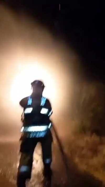 Fireman using water as a shield