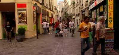 Gordon Giving Someone the Middle Finger in Paris While Armed With Tempting Tarts