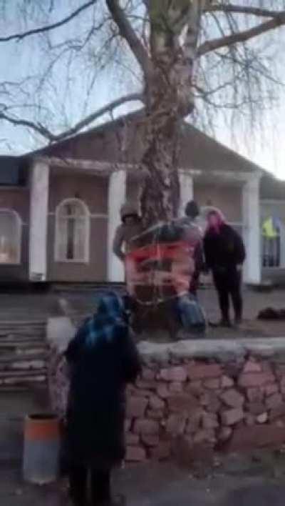 Man and woman caught looting a fallen Ukrainian soldier’s home by the entire village in Zhytomyr.