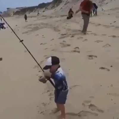 Little man landing a big fish