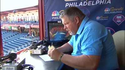 John Kruk eating a hog dog.