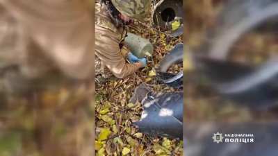 Sappers of the emergency sevice discharging an explosive part from crashed Russian drones in Kyiv