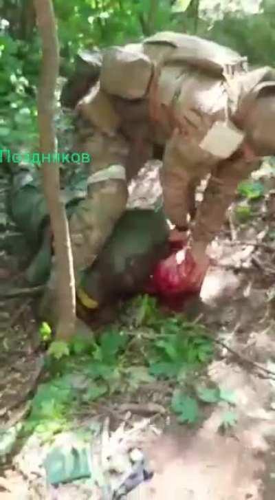 Disturbing footage, russians beheading a captured ukrainian soldier. Not for the faint of heart.