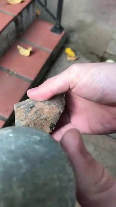 Breaking open an Obsidian rock